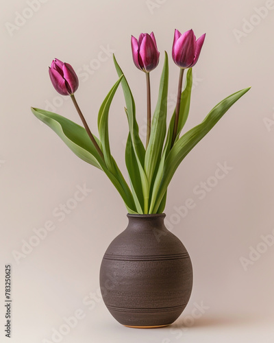 A minimalist ikebana style arrangement featuring three magenta tulips.