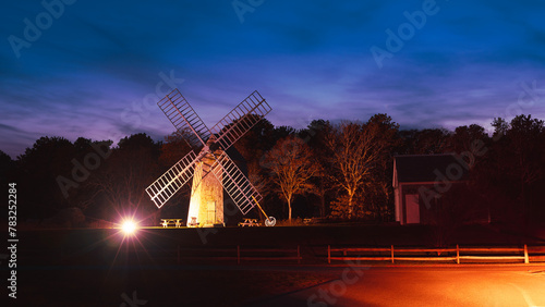 Daybreak over Brewster Windmill and illuminated street at Historical Village Park in Barnstable County on Cape Cod, Massachusetts, USA photo