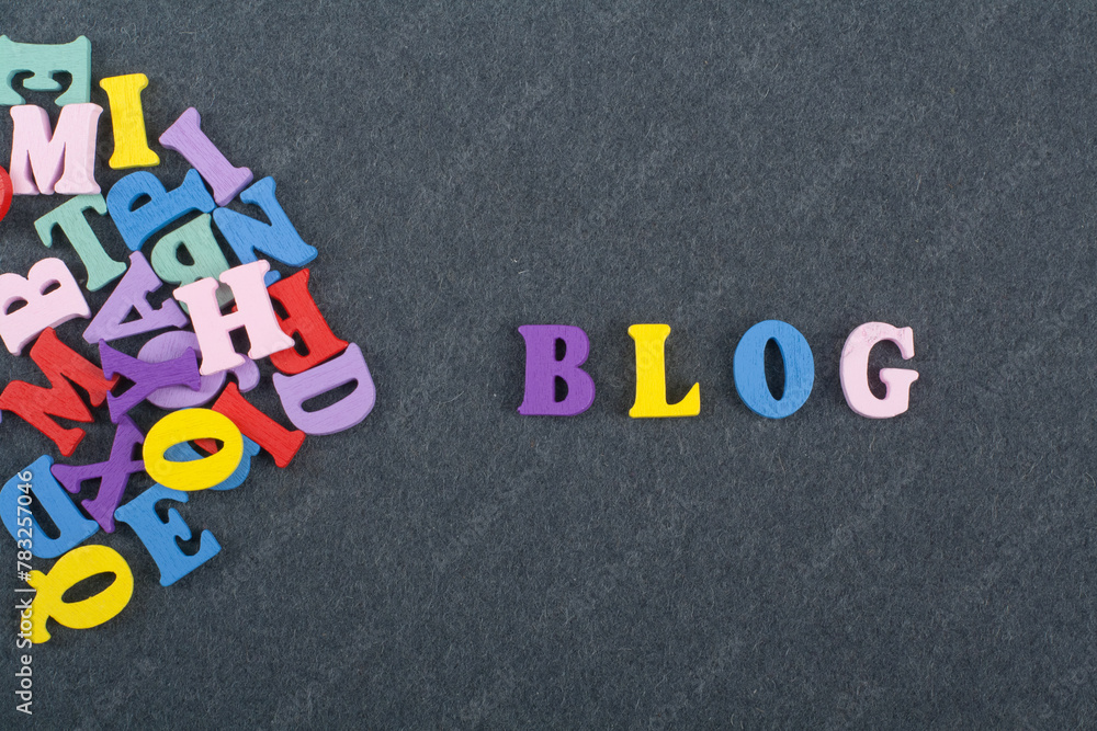 Obraz premium BLOG word on black board background composed from colorful abc alphabet block wooden letters, copy space for ad text. Learning english concept.