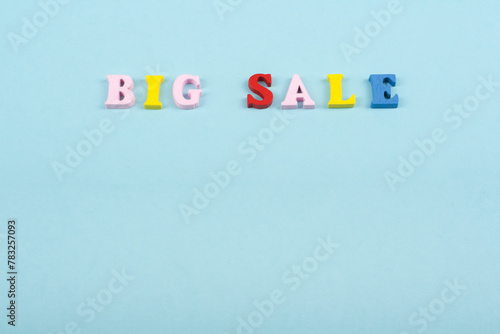 Big sale word on blue background composed from colorful abc alphabet block wooden letters, copy space for ad text. Learning english concept.