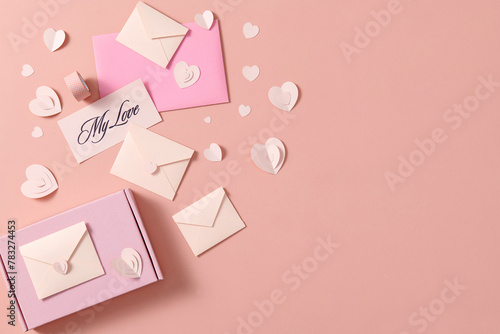 Gift with paper hearts on beige background with space for text photo