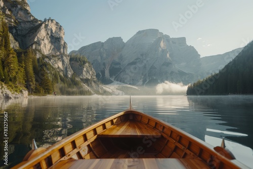 Boat sailing on lake with mountains in background