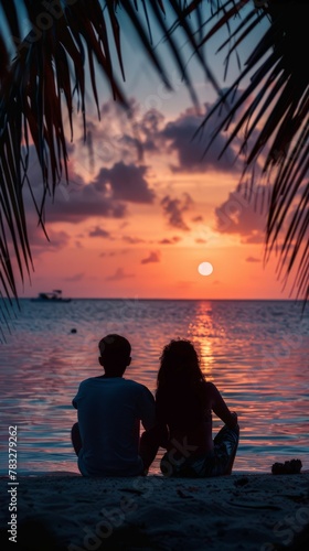 Two people watching sunset on beach © BrandwayArt