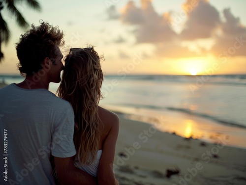 Man and woman standing on beach at sunset