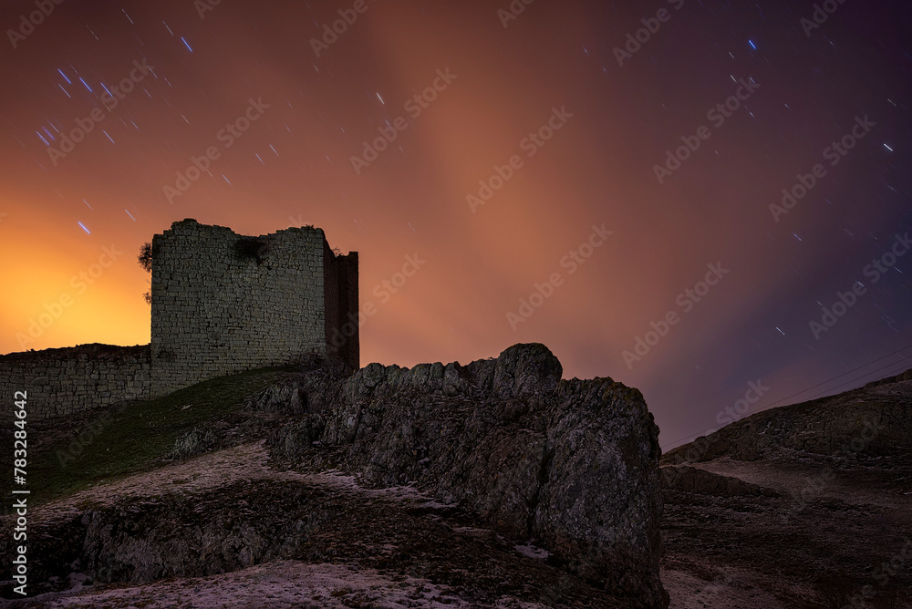 Night view of the ruins of the medieval castle of Monasterio de Rodilla, Burgos, in the region of La Bureba, declared a site of cultural interest and historical heritage of Spain