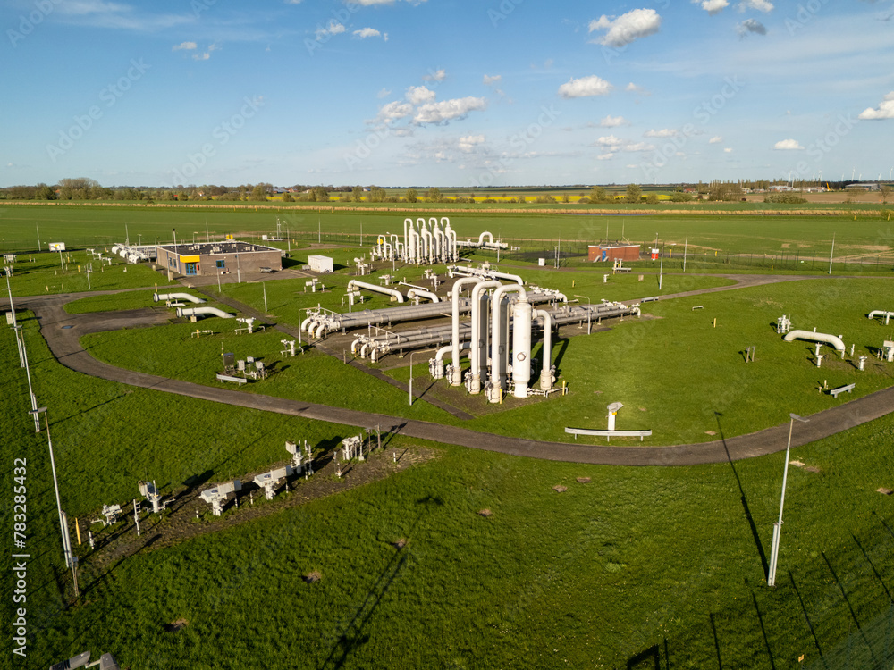 Obraz premium Controversial Gas Field in Groningen: Aerial View of Industrial Pipelines in Farmland