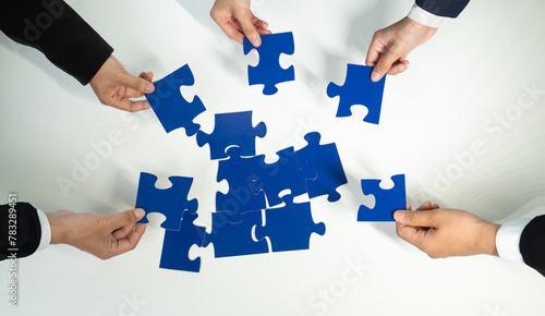 Top view panorama banner of business team assembling jigsaw puzzle over table symbolize business partnership and collective teamwork for HR recruitment and job seeker background. Shrewd © Summit Art Creations
