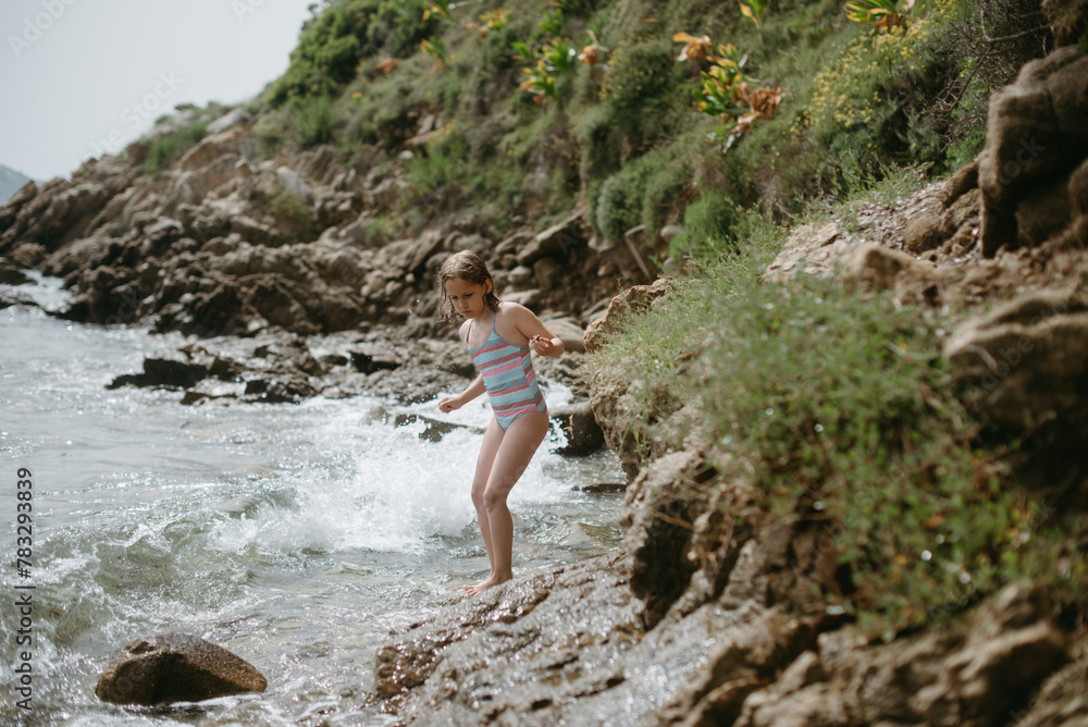 Adventurer girl in rocky beach