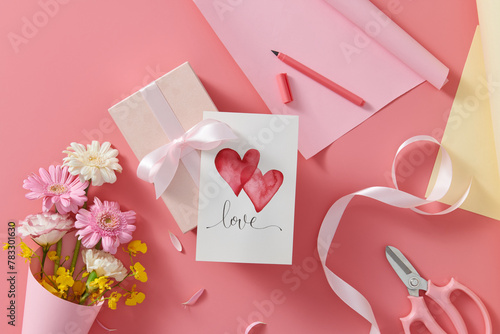 Greeting card and envelop in pink with love text and flowers photo