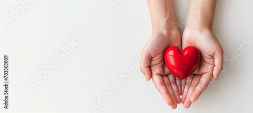 Woman hands holding red heart supporting blood donation to save life concept, isolated on white background.