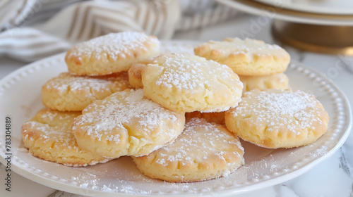 Ghorayeba, delicate egyptian butter cookies dusted with powdered sugar, on a white plate