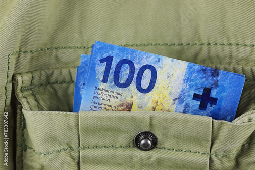 A 100 Swiss franc notes in a jacket pocket, CHF photo