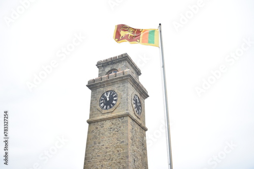 Galle Clock Tower and the Sri Lankan national flag that waving in Galle Fort, Galle, Sri Lanka.