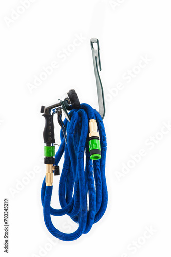 Blue watering hose hanging on a special hanger, isolated on a white background. High quality photo