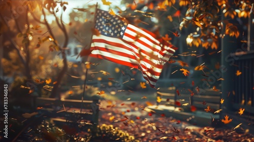 An American flag gently waving in a gentle breeze against a backdrop of falling autumn leaves in warm hues of red, orange, and yellow.
