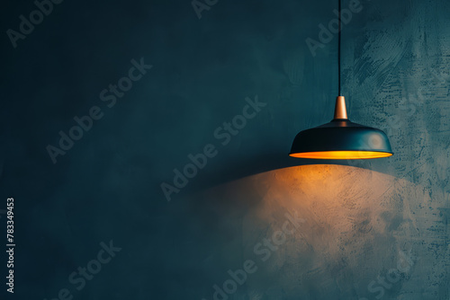 A lamp hangs against a dark wall, casting its light and illuminating the area, with space available for text or presentation.