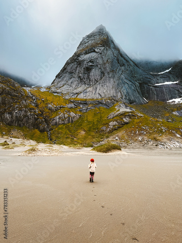 Child walking on Bunes beach in Lofoten islands Travel vacations kid exploring Norway adventure outdoor wild scandinavian nature