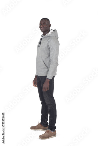 side view portrait of a man standing and looking at camera on white background