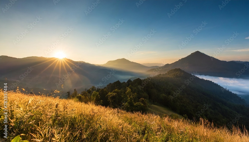 beautiful sunrise in the mountain meadow landscape refreshment with sunray and golden bokeh