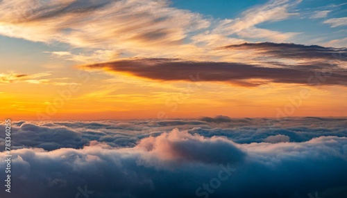 bask in warm glow of a sunset as fluffy clouds don a peachy hue creating a celestial canvas in the vast serene sky photo