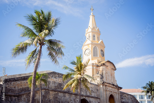 View of the Clock Tower landmark in the center of the known Walled City of Cartagena Province during a sunny day with very hot weather.  photo