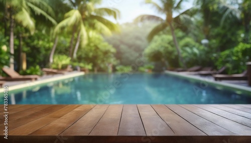 empty wood table top and blurred swimming pool in tropical resort in summer banner background can used for display or montage your products