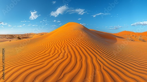  A sand dune in a desert's heart, encircled by a blue sky, dotted with white clouds
