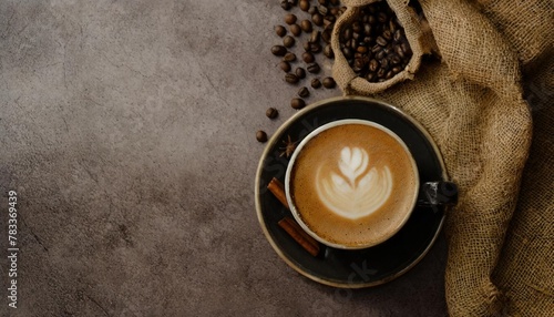 top view of cappuccino coffee with brown fabric on a textured background empty space for placing advertising text on the background cafe and bar barista art concept long banner