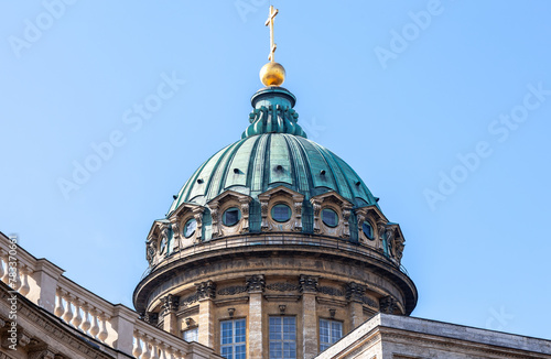 Dome of the Kazan Cathedral with golden religious cross against a sky in St. Petersburg, Russia