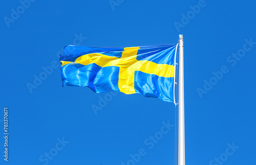 Swedish flag blowing in the wind on a sunny day