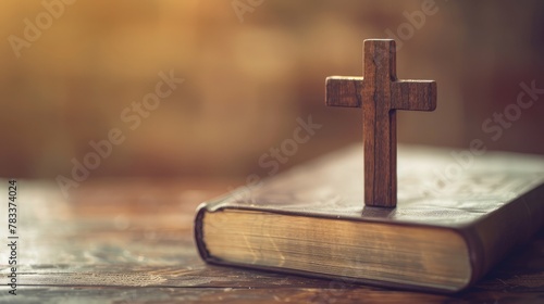 Closeup of simple wooden Christian cross on Bible , vintage tone , god
