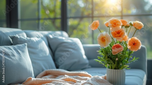 A Living Room With a Couch and a Vase of Flowers