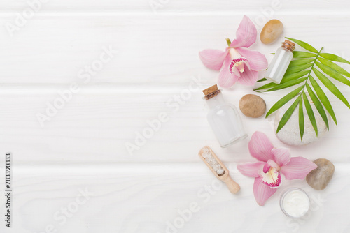 Composition with orchids, spa products on wooden background, top view