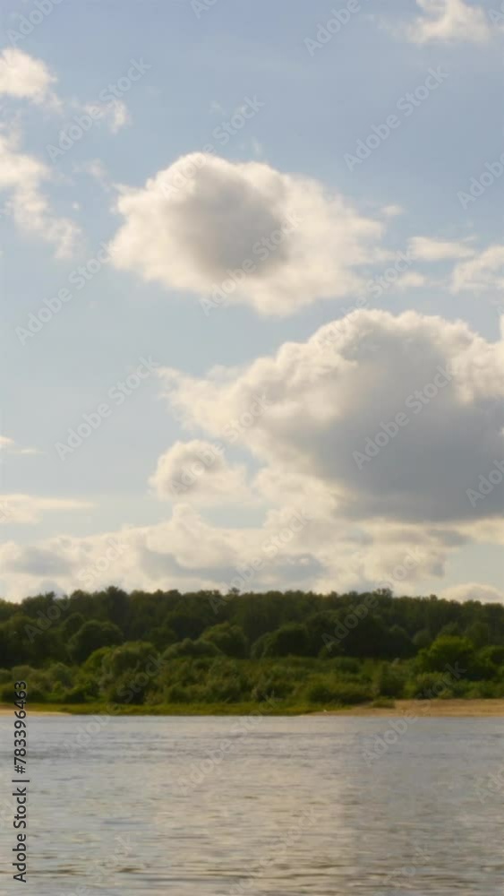 A Sunny Day By The Lake. Forest Shores And Clouds In The Blue Sky. Vertical. Timelapse. A Sunny Day By The Lake. Forest Shores And Clouds In The Blue Sky. Vertical. Timelapse.