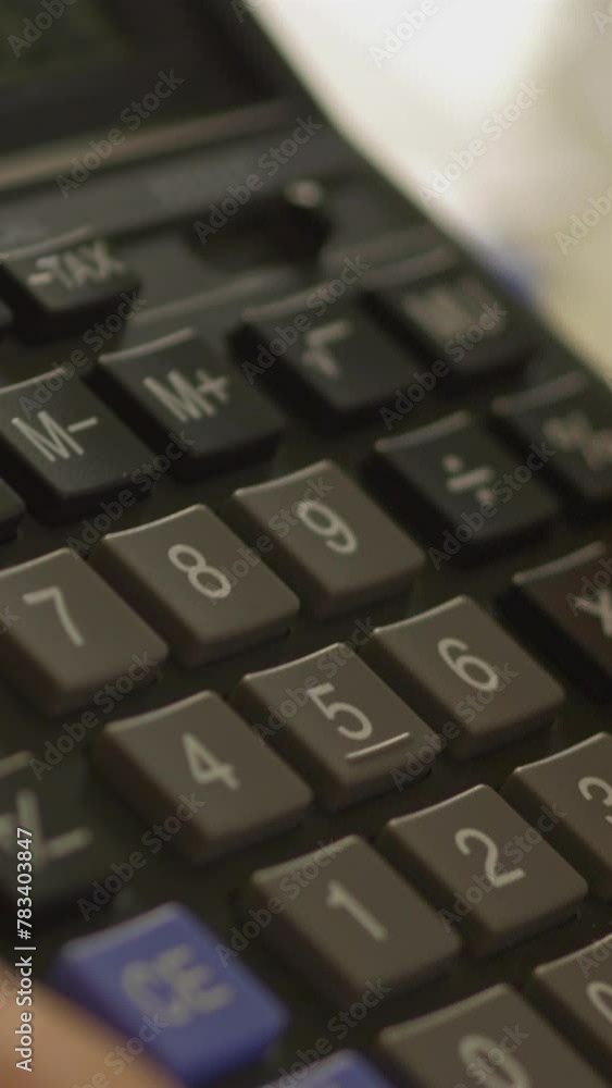Man Using Calculator For Financial Planning. Vertical
Man Using Calculator For Financial Planning. Vertical