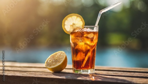 refreshing iced tea with a lemon slice at sunset outdoor wooden table setting food and drinks lifestyle concept for beverage collection
