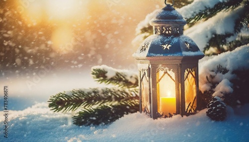 christmas lantern on snow with fir branch in the sunlight winter decoration background © Mac