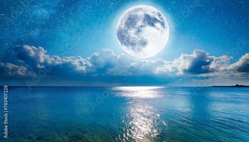 romantic moon with clouds and starry sky over sparkling blue water © Mac