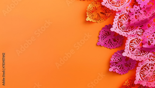bright orange background with mexican papel picado for cultural celebrations, cinco de mayo  photo