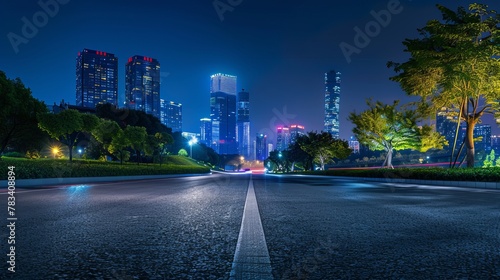 An asphalt road winding through the cityscape of Suzhou  China  featuring modern buildings illuminated against the night sky.