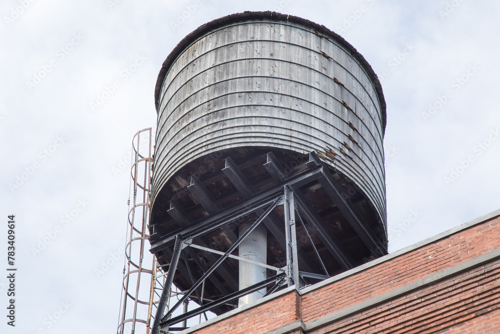 An old wooden water tower on an industrial building An old wooden water tower on an industrial building