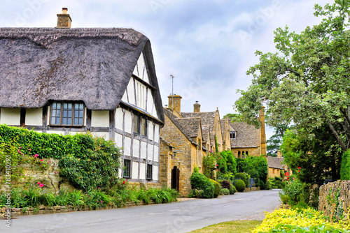 Beautiful Cotswolds village with half timbered thatched roof house, Stanton, Gloucestershire, England photo