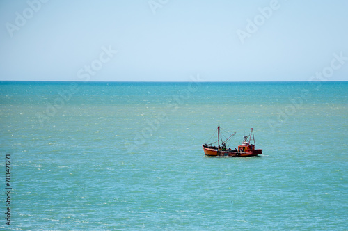 fishermen from a coastal fishing boat collecting the net in the sea © phjacky65