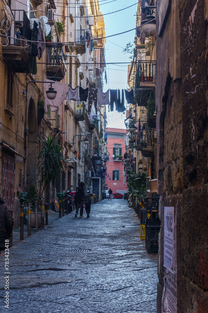 Typical townscape of dark narrow streets and alleys in the city of Naples, Campania, Italy