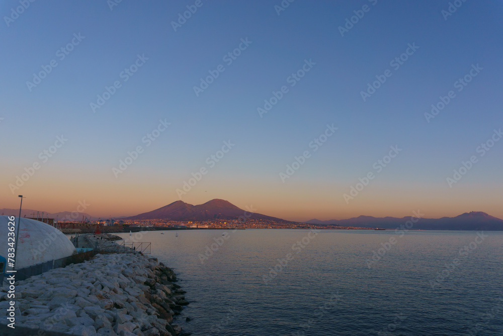 Mount Vesuvius over the city of Naples during golden hour at sunset, Naples, Campania, Italy Mount Vesuvius over the city of Naples during golden hour at sunset, Naples, Campania, Italy