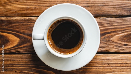 white cup and saucer with freshly brewed strong black espresso coffee with crema isolated beverage design element top view flat lay