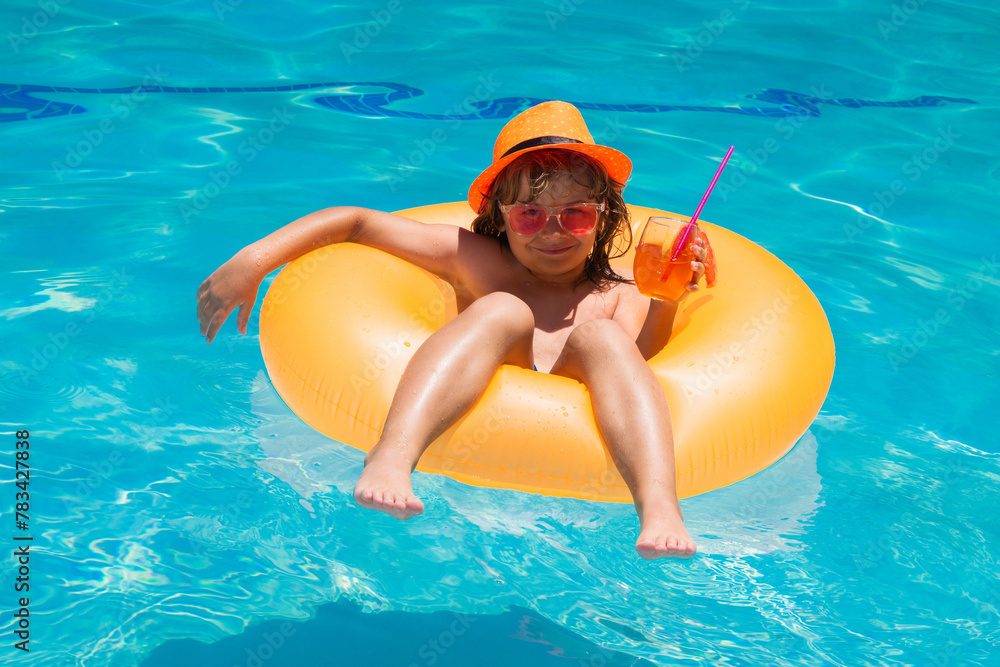 Kid floating in pool. Child relaxing in pool, drink summer cocktail. Kids summer vacation. Children floating in water pool. Children playing and active leisure, swimming pool concept.