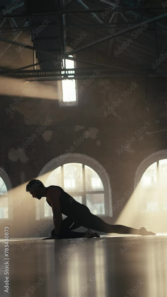 Vertical video silhouette of a male athlete in a black sports summer ...