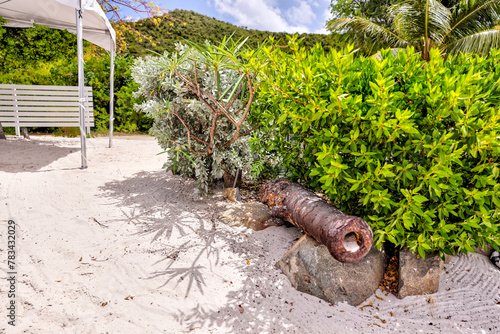 Tortola, British Virgin Islands - March 27, 2024: A rusted cannon on the beach at The Bight on Norman Island 