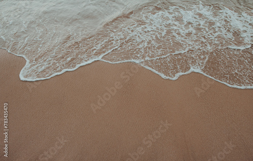 beach sand with waves arriving